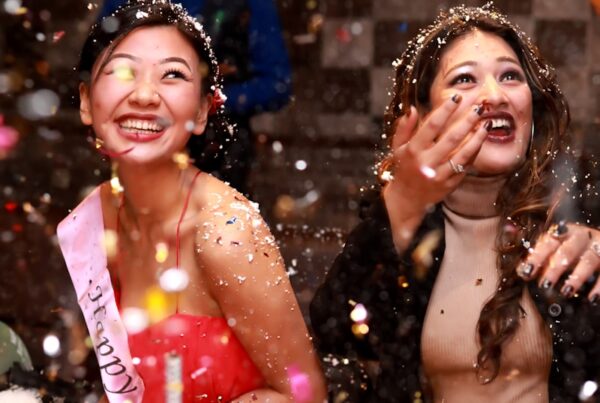 time-lapse photography of two women splashing glitters